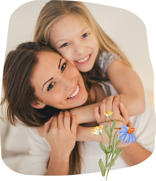 Young girl and her mother smiling and hugging