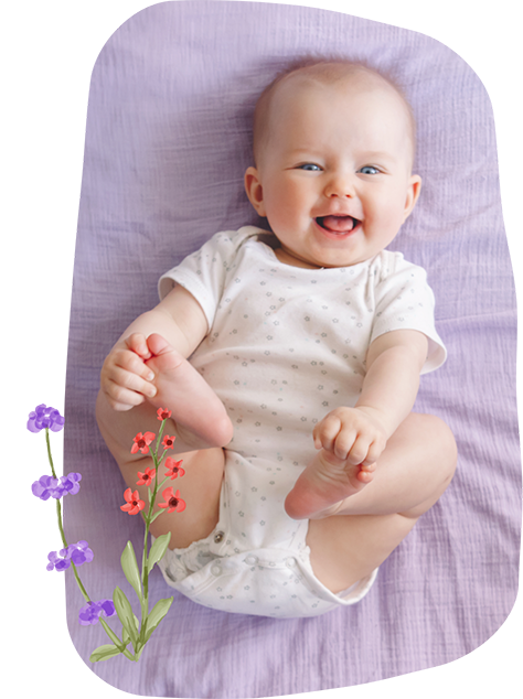 Baby laughing and touching their feet while lying on their back