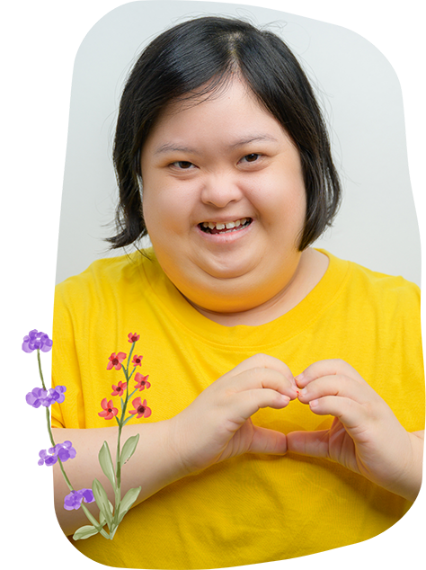 Girl smiling and making a heart shape with her hands