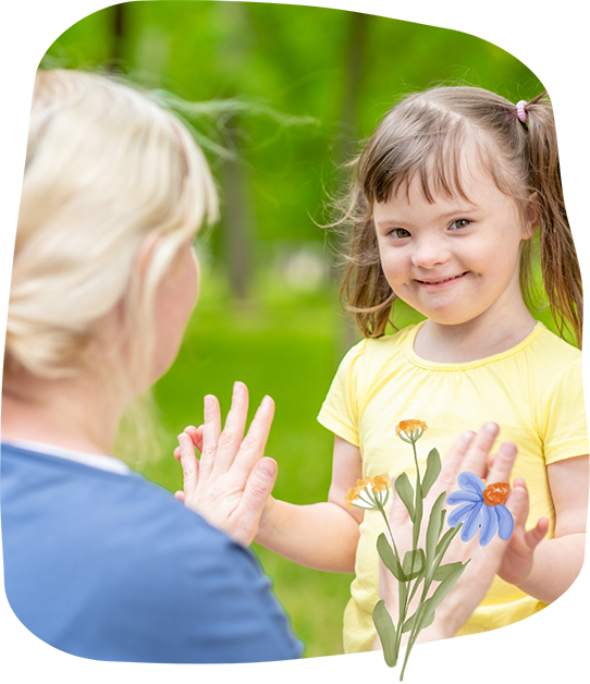 Young girl with Down syndrome giving a high five to her mother