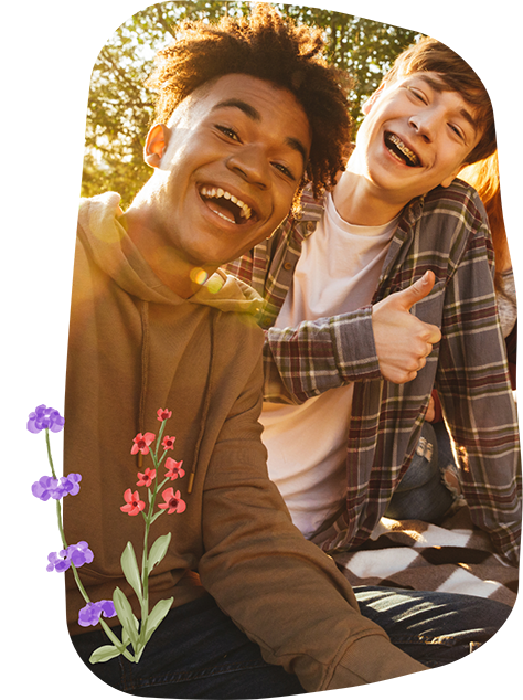 Two teenage boys smiling in the sun