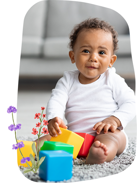 Toddler sitting on the floor with building blocks