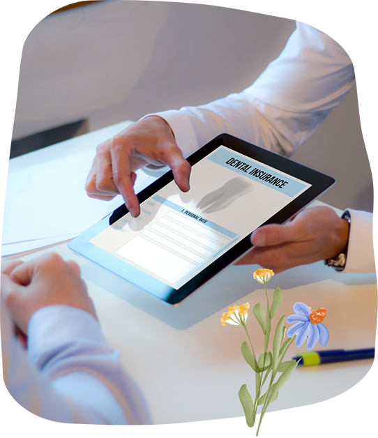 Two people looking at dental insurance information on a tablet
