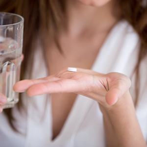 Lady prepares to take pill