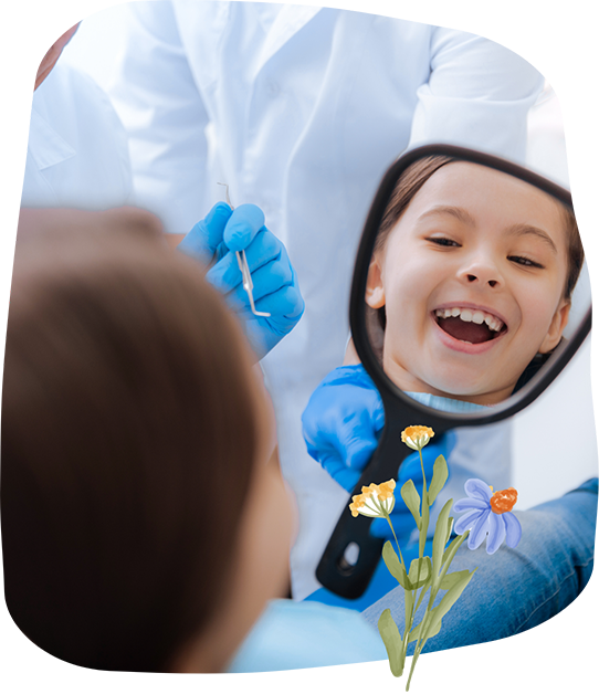 Young boy in the dental chair looking at his smile in a mirror