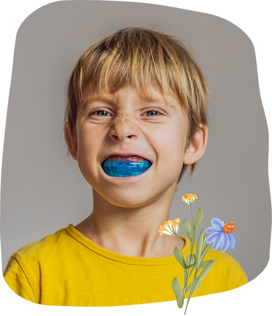 Boy wearing a blue mouthguard over his teeth