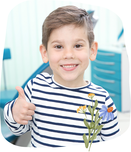 Boy in the dental office smiling and giving a thumbs up